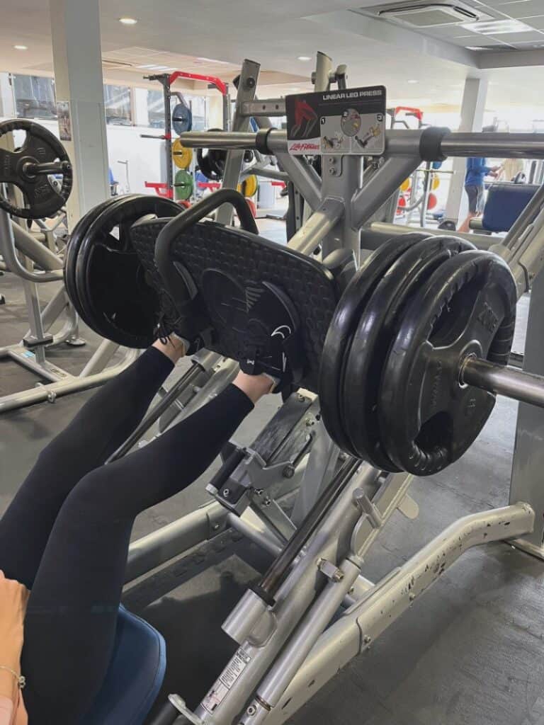 Lady on leg press in the gym